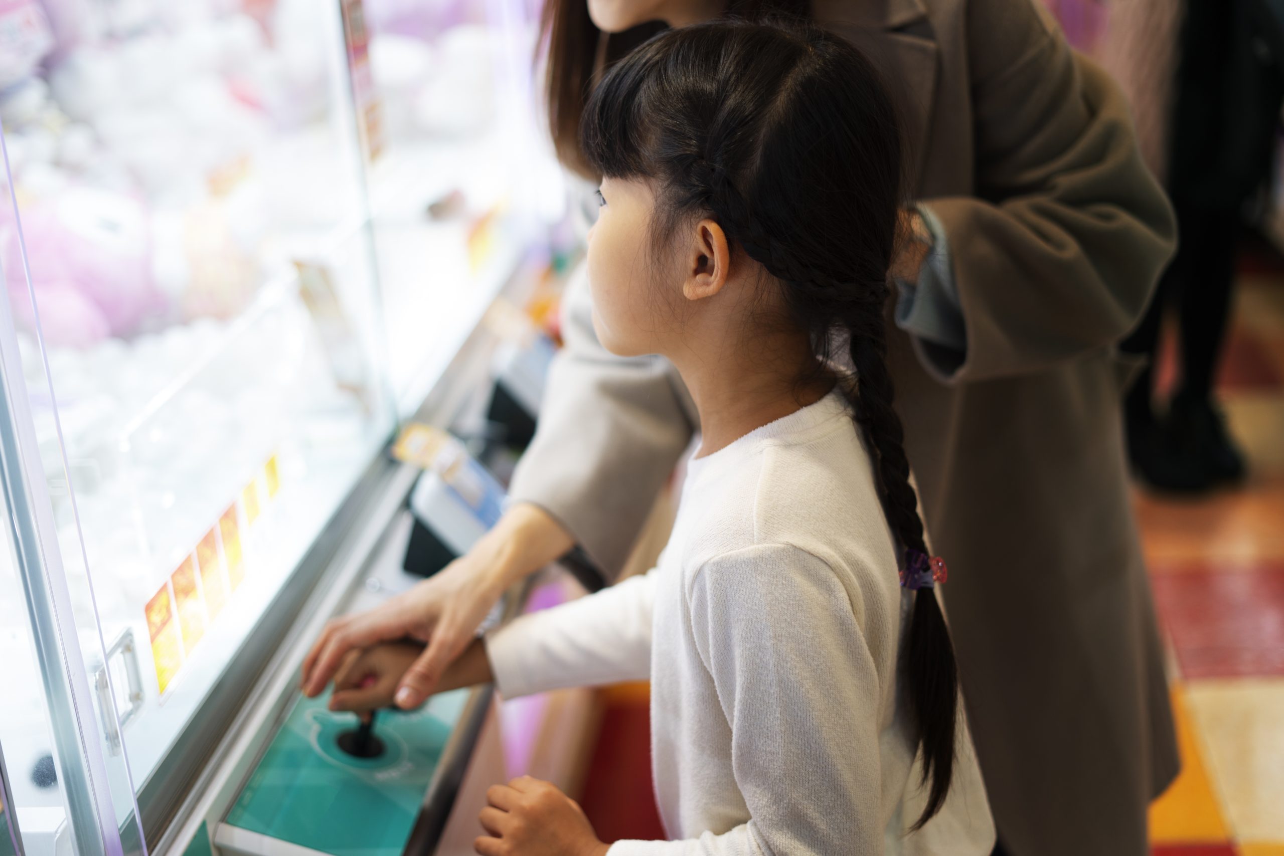Child playing an arcade game at a company family day event