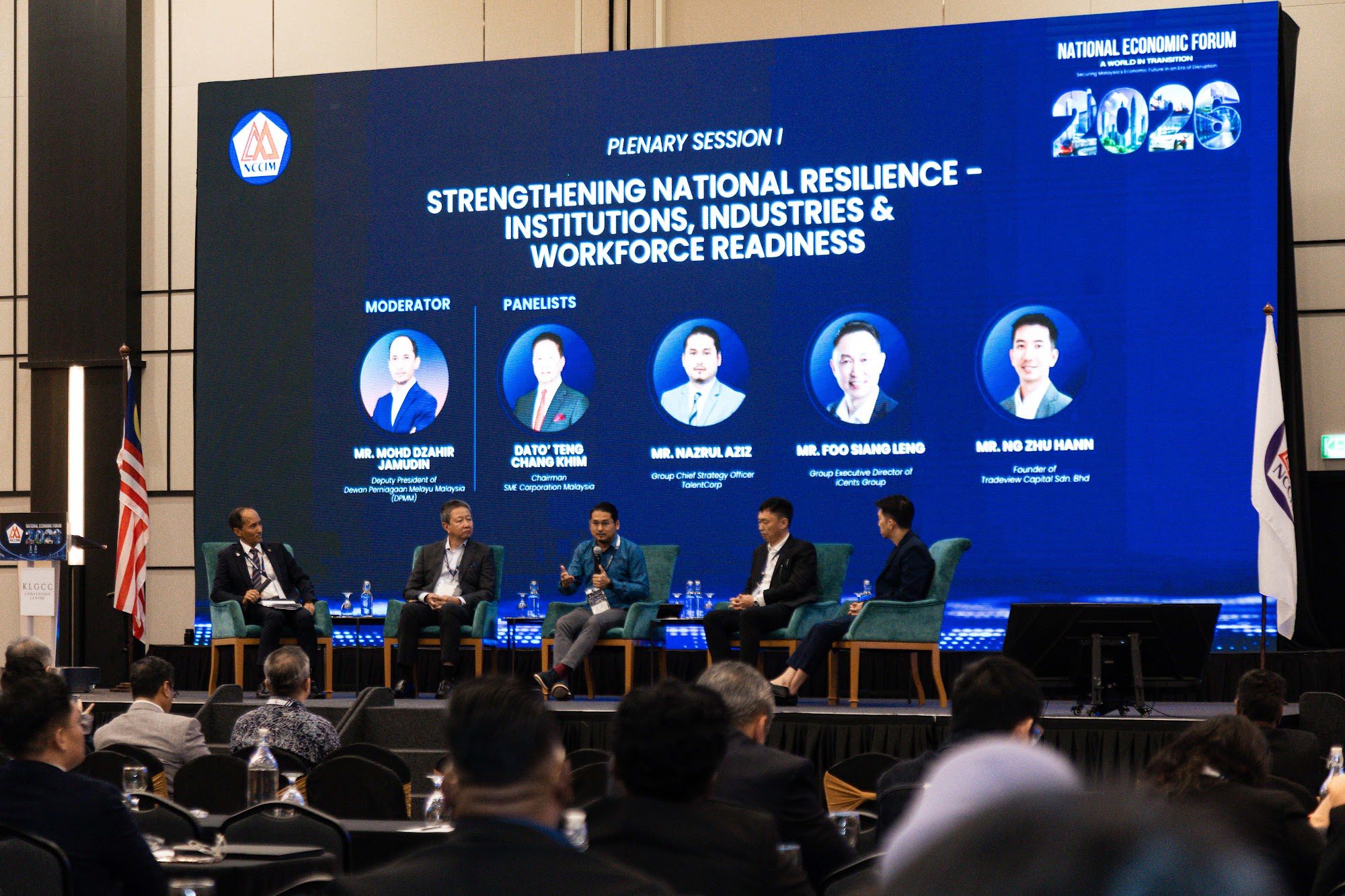 Panel of speakers on stage during a plenary session at a business conference in Malaysia