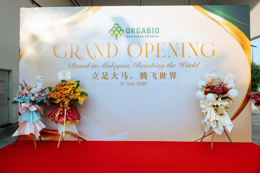 Grand opening backdrop with flower stands and a red carpet at a corporate launch event