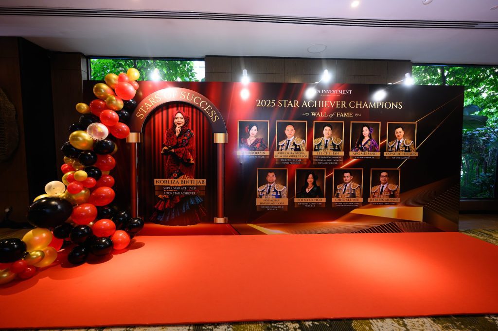 Red carpet photo wall with a balloon arch and award winner portraits at a gala dinner